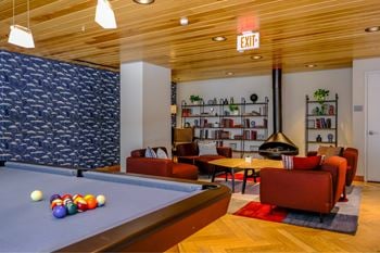 Expansive club room with fireplace, pool tables, full kitchen